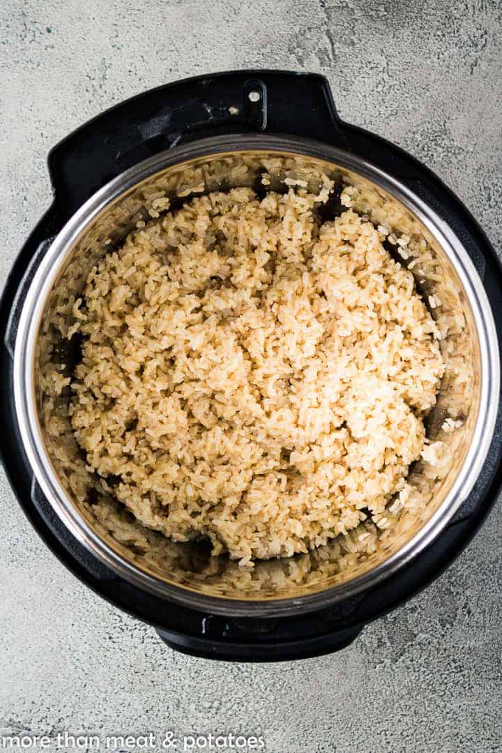 The brown rice has pressure cooked and is ready to serve.