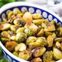 Roasted Brussel sprouts in a colorful blue dish.