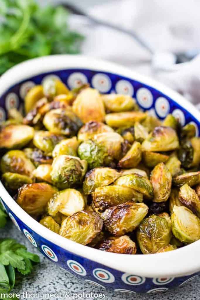 Roasted brussel sprouts in a colorful blue dish.