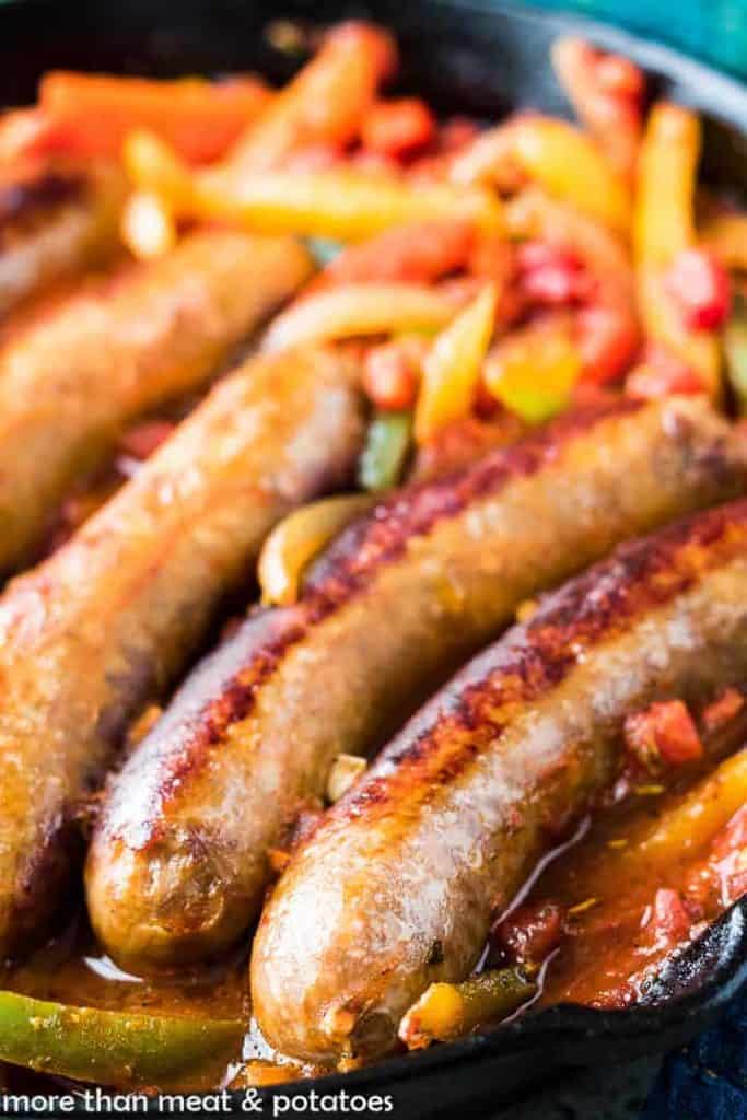 A close-up of the peppers and sausage in the pan.