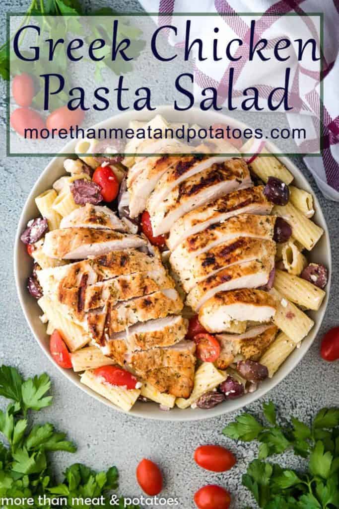 Top down view of a large bowl pasta salad with grilled chicken.