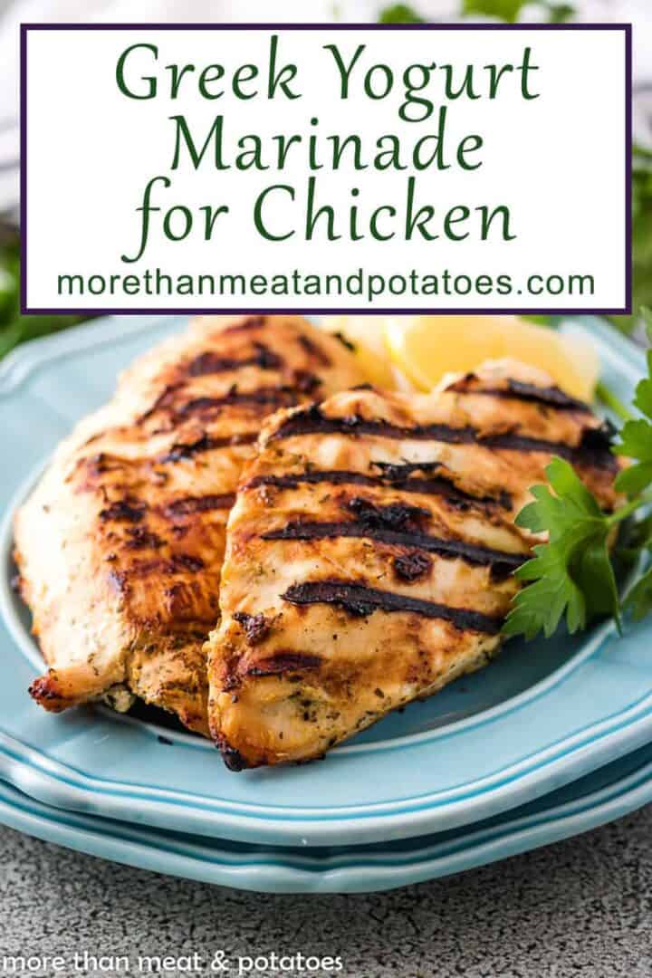 Two blue plates with grilled chicken breasts and a box containing text "greek yogurt marinade for chicken. "