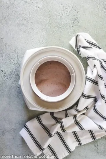 Cherry vanilla ice cream churning in a maker.