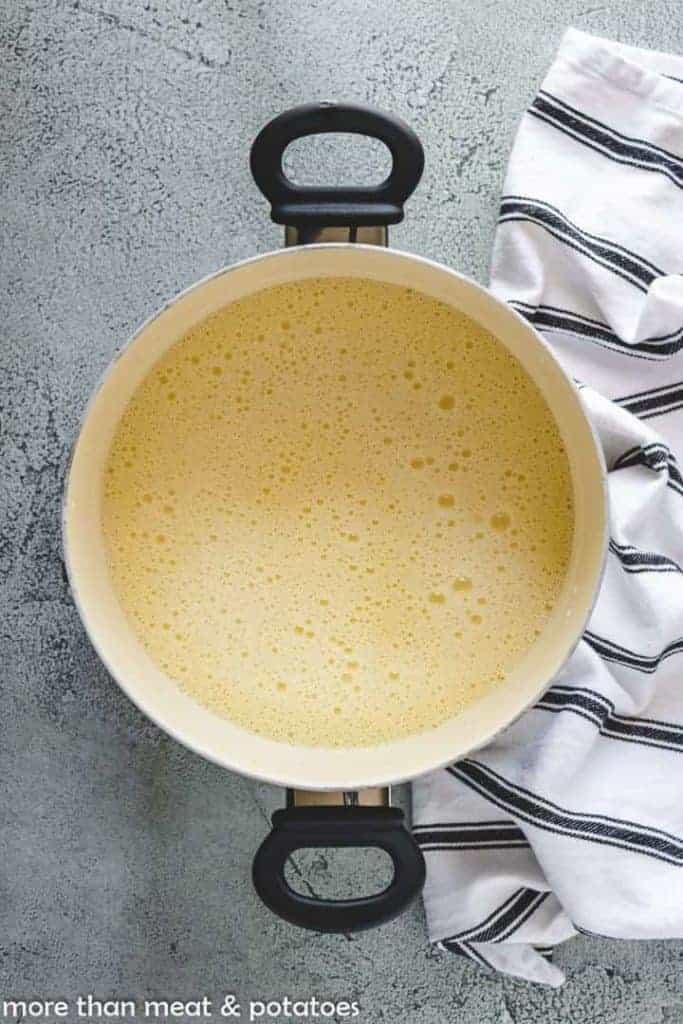 The vanilla custard base cooking in a pan.