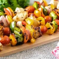 Tender grilled chicken with charred veggies on a skewers.