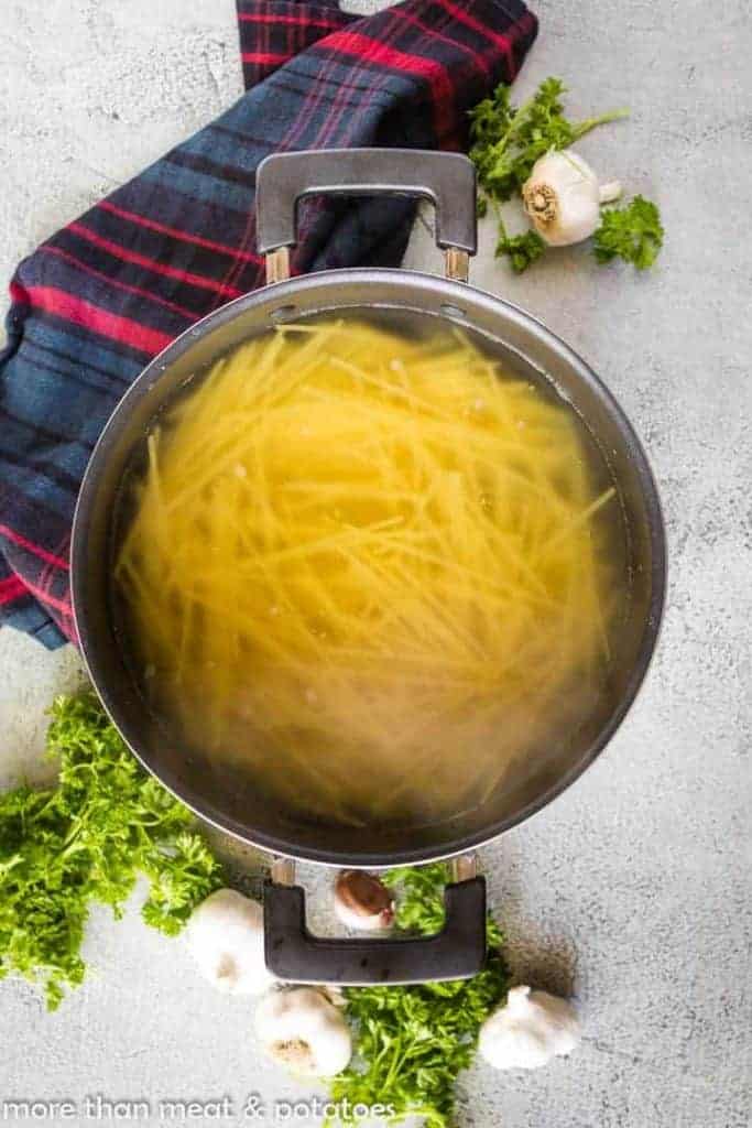 Cooking spaghetti in a stock pot with salted water.