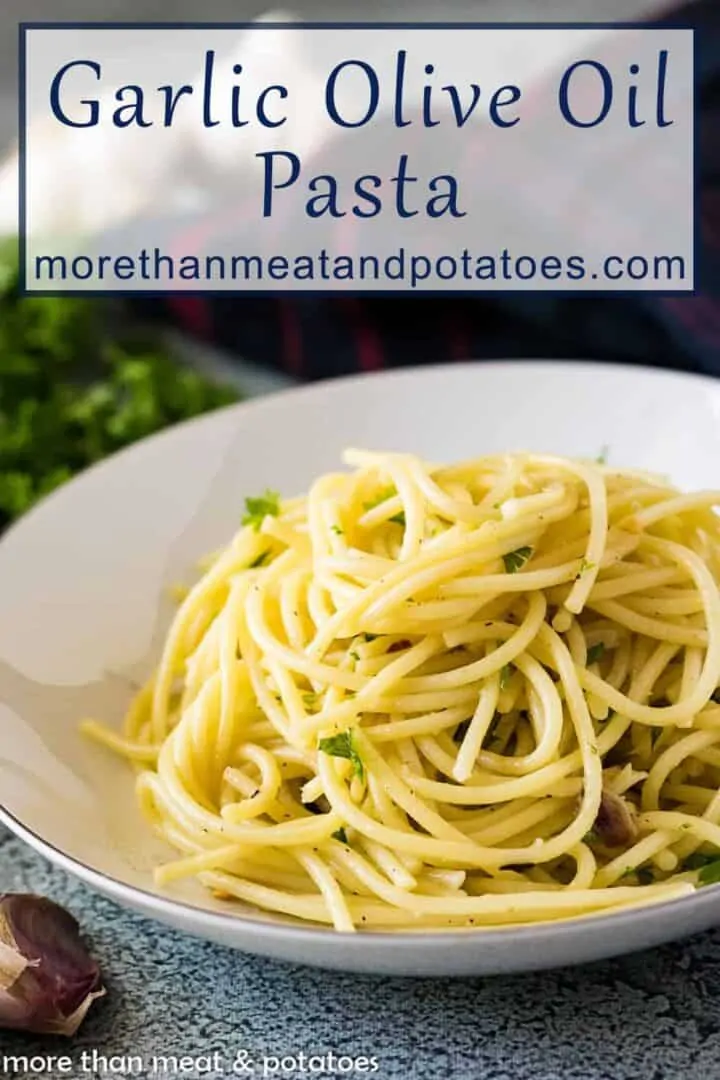 Roasted garlic and olive oil spaghetti in a bowl topped with parsley.