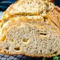 The sliced rosemary Parmesan bread on a cooling rack.