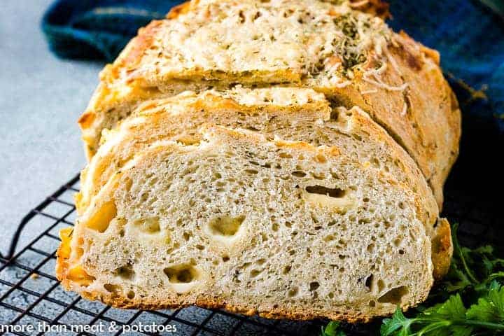 The sliced rosemary Parmesan bread on a cooling rack.