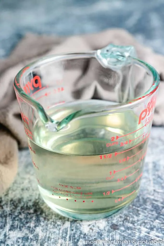 Coconut water and sugar in a measuring glass.