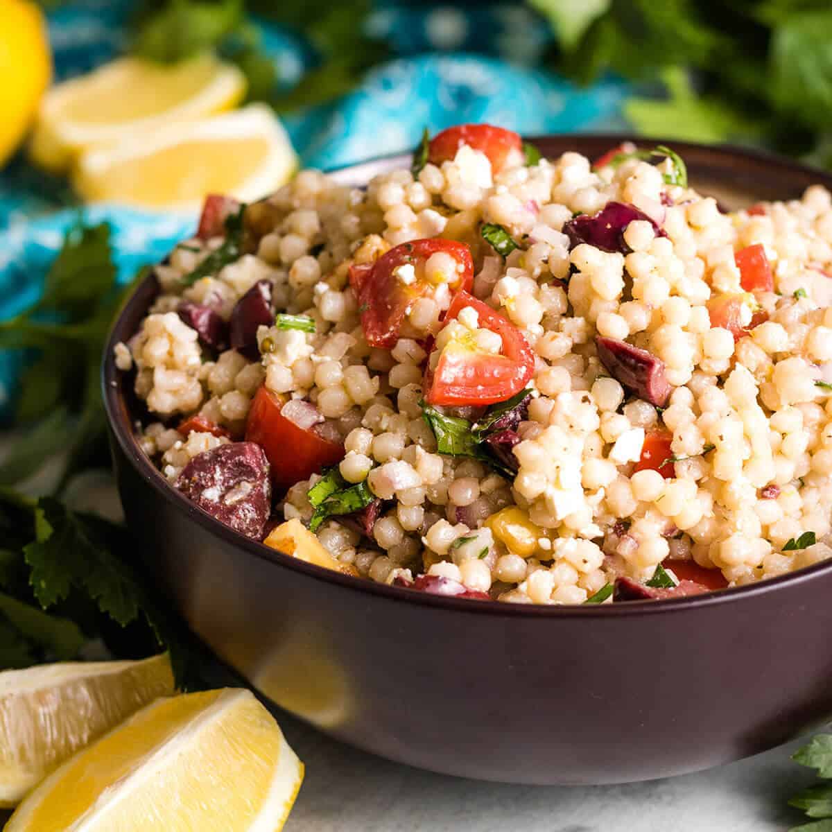 The lemon couscous salad served in brown bowl.