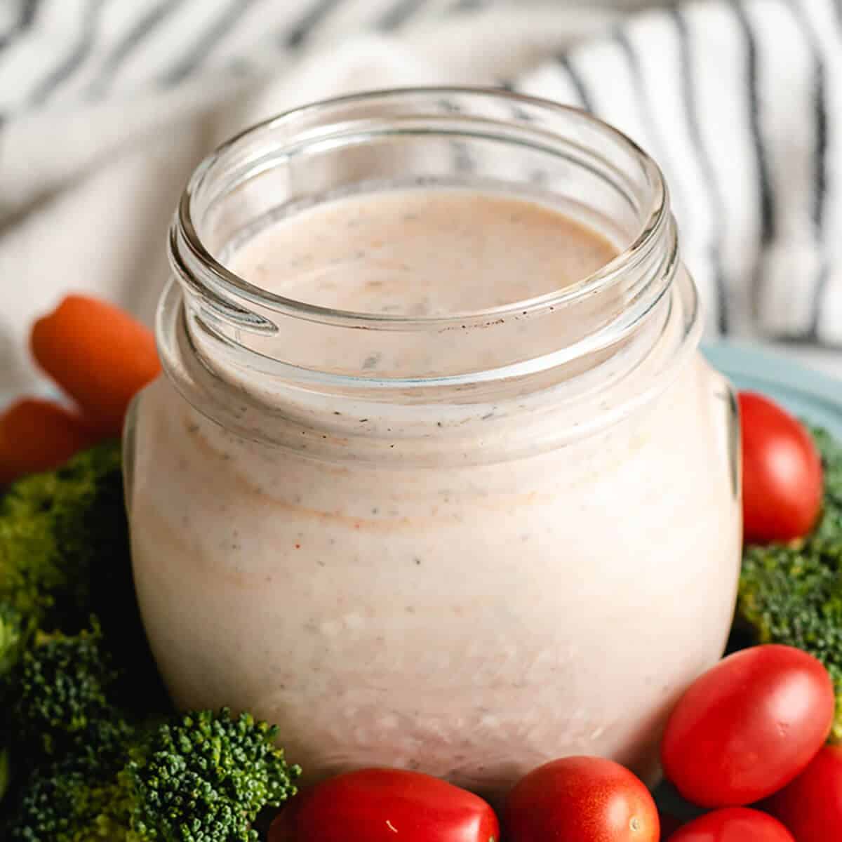 Homemade ranch dressing no mayo in a mason jar with veggies.