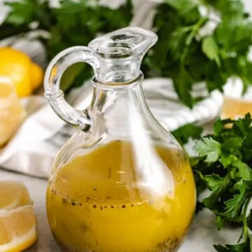 The vinaigrette has been transferred to a glass cruet.