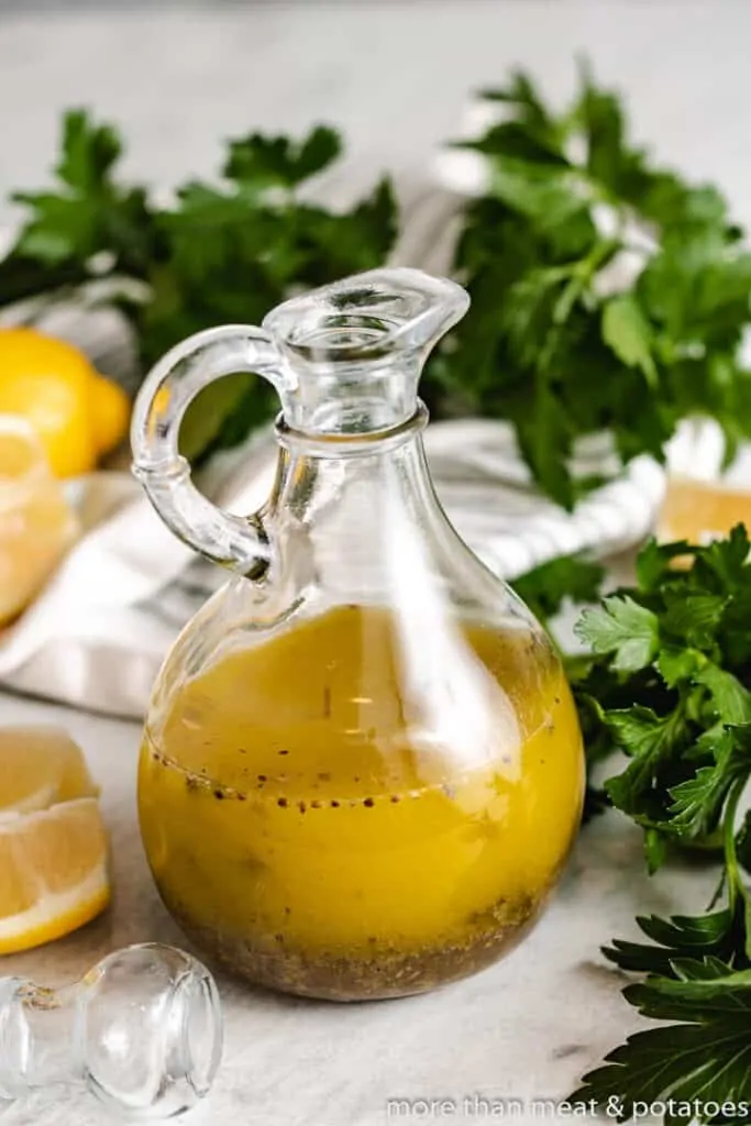 The vinaigrette has been transferred to a glass cruet.