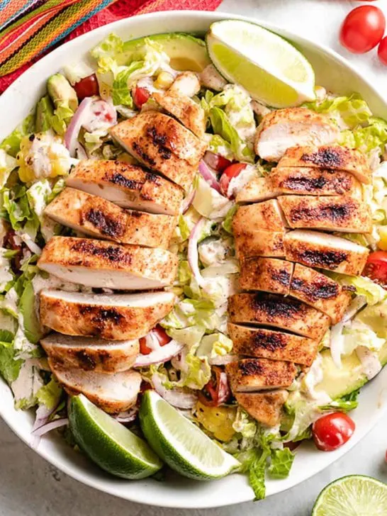 An aerial view of the grilled chicken salad in a bowl.