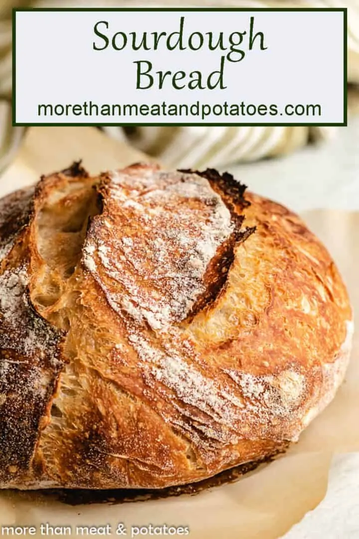 Loaf of baked bread on parchment paper.