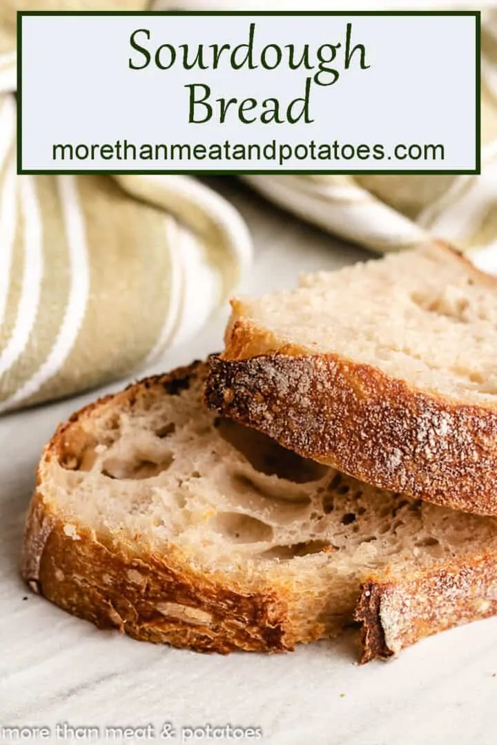 Two slices of sourdough bread layering on one another with a green towel.