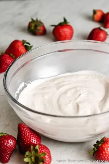 Whipping cream and other ingredients whipped in a bowl.