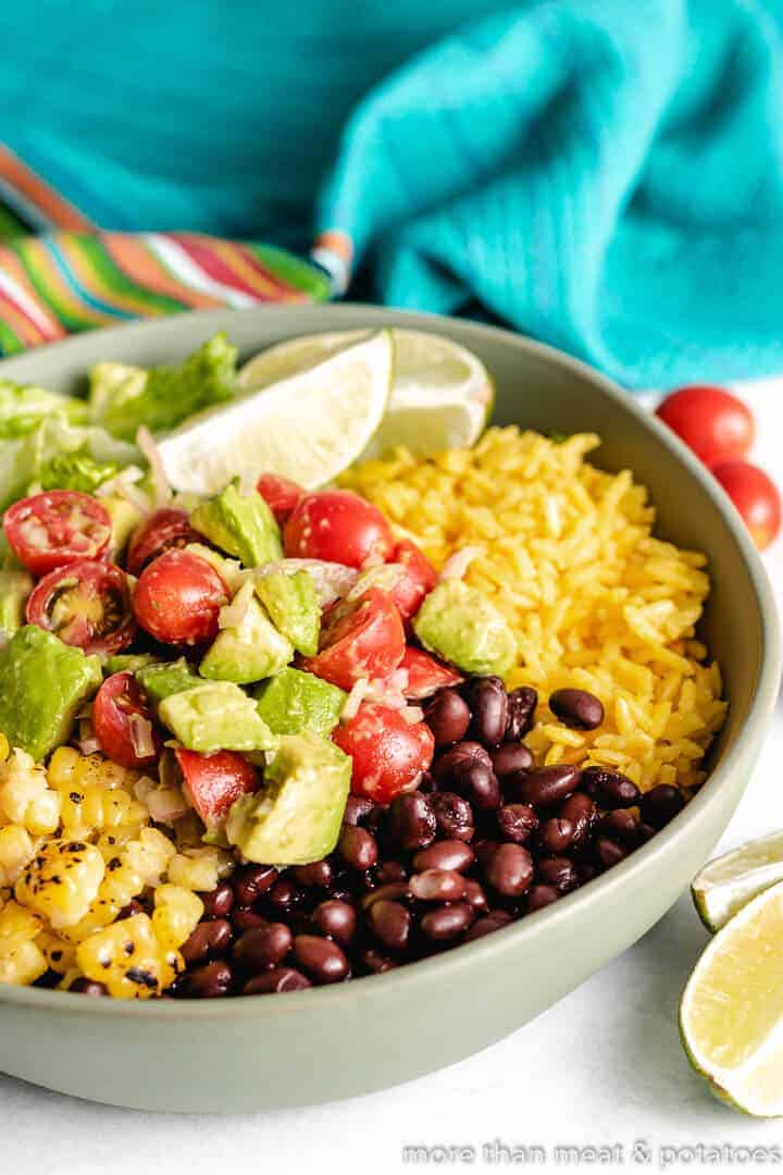 Lettuce, tomatoes, and other ingredients in a serving dish.