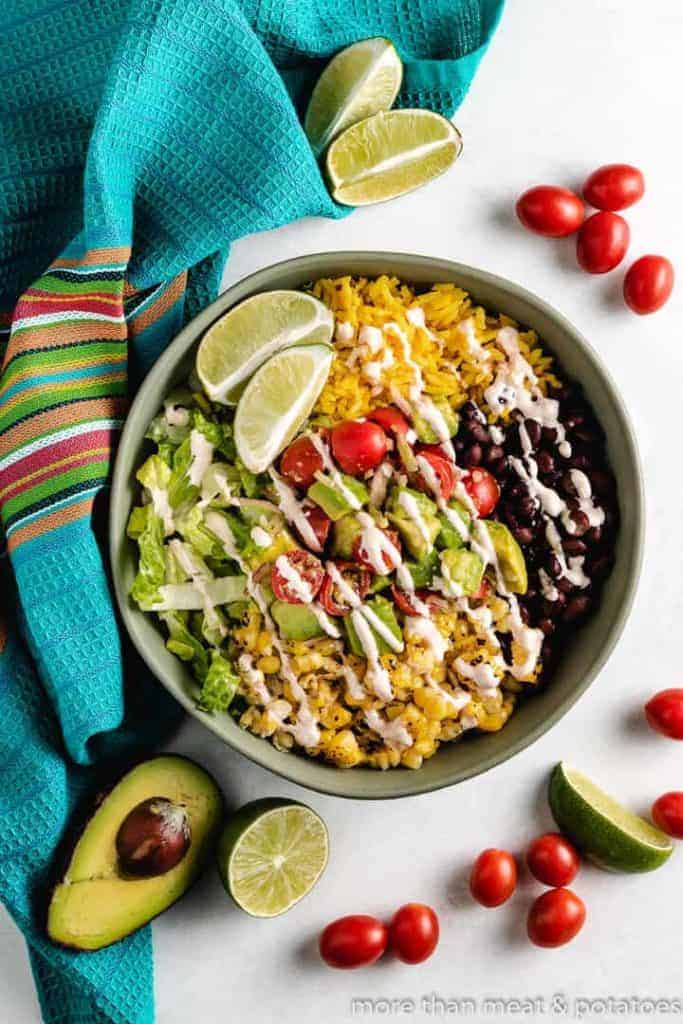 An aerial view of the burrito bowls with dressing.