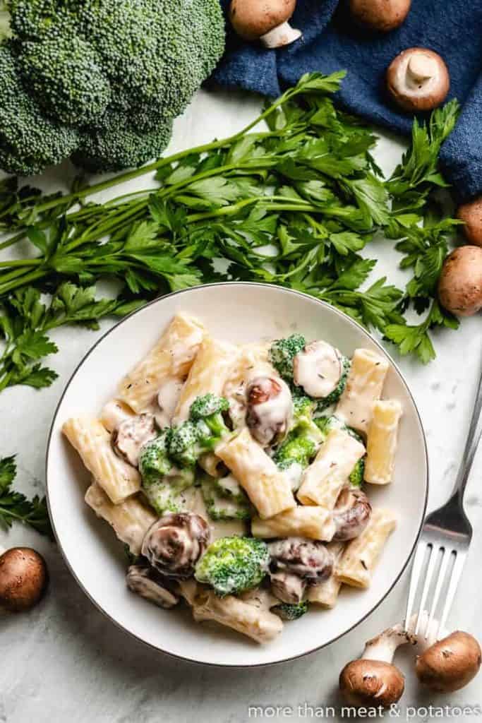 Plate of broccoli pasta with mushrooms.