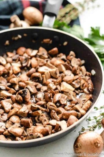 Mushrooms and garlic in a saute pan.