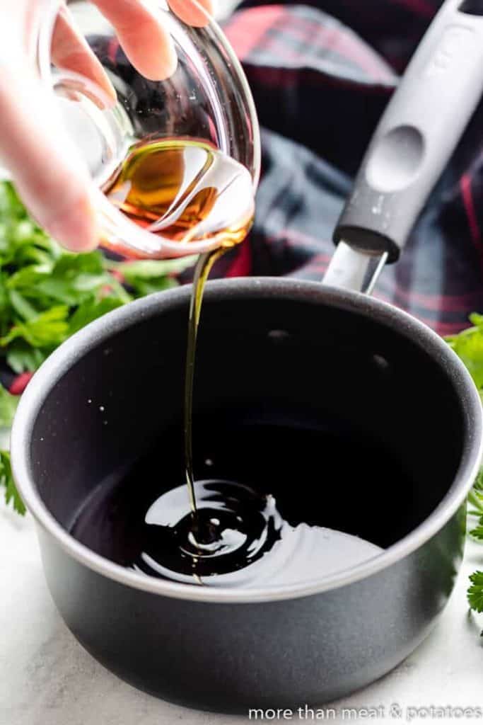 Maple syrup being added to balsamic vinegar.