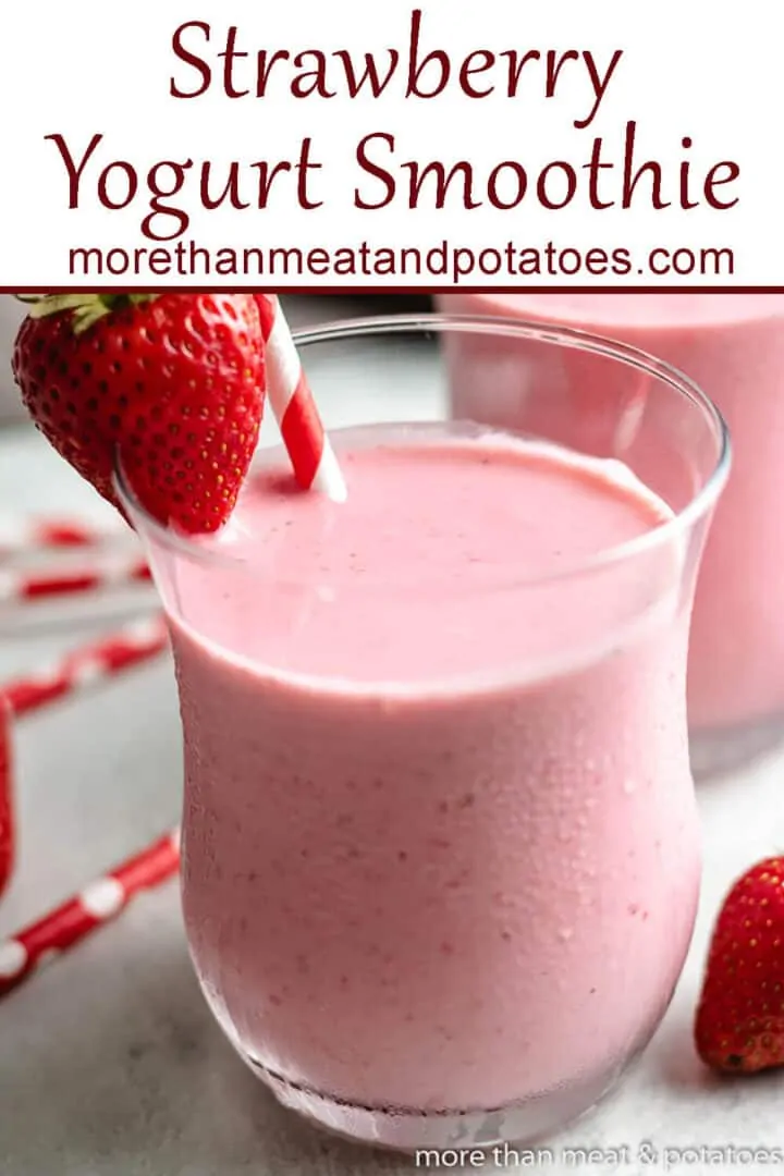 A strawberry greek yogurt smoothie garnished with a fresh berry.