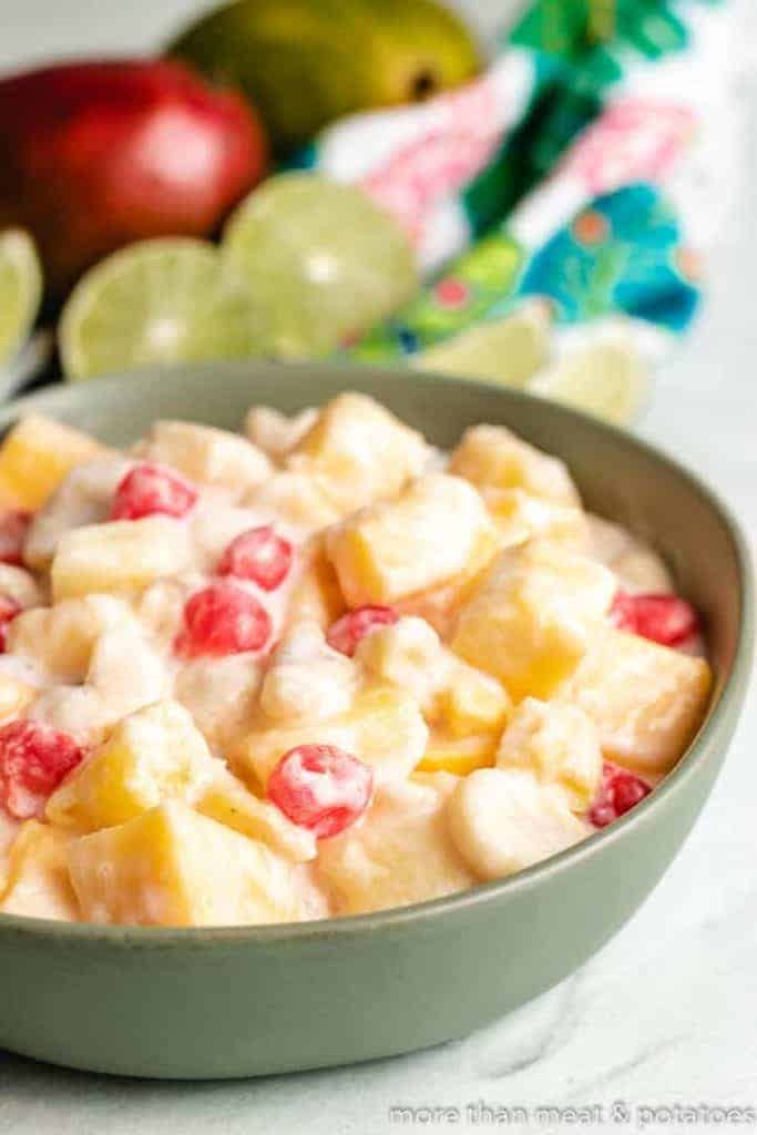 Tropical Fruit Salad with Coconut The finished tropical fruit salad with coconut dressing in a bowl.