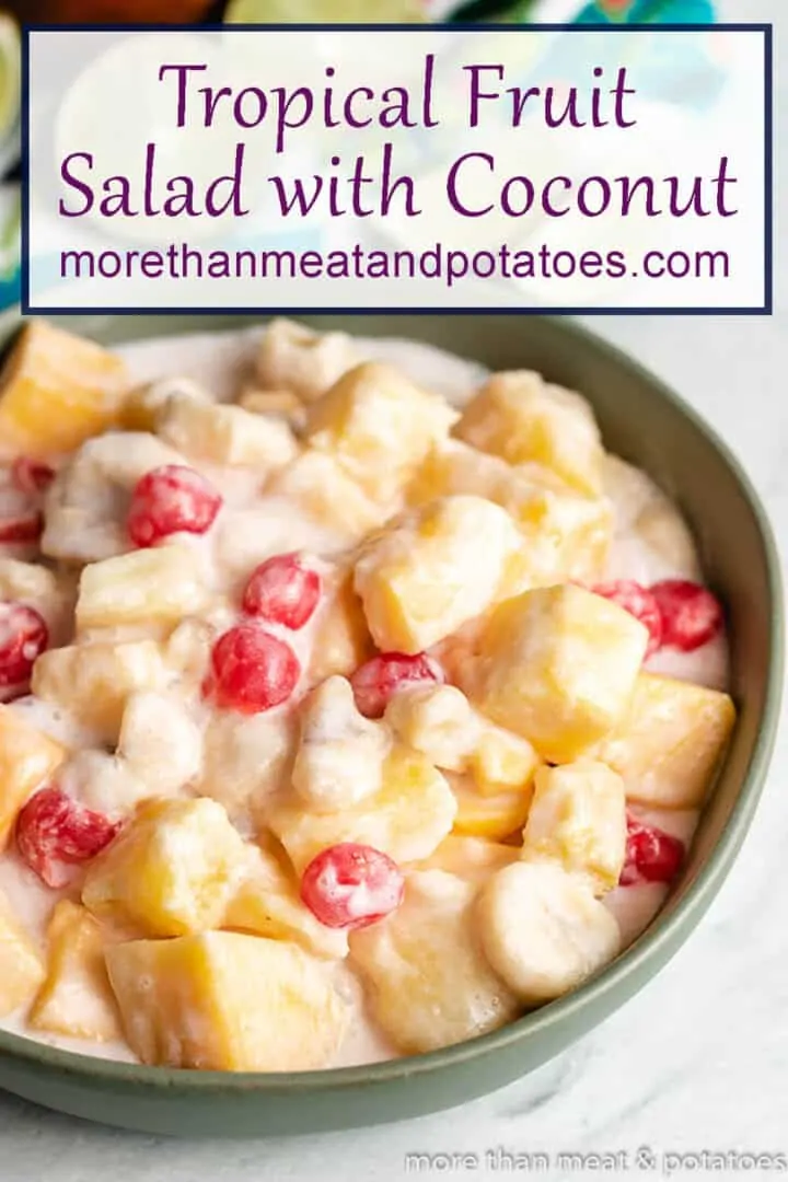 Aerial view of the tropical fruit salad in a green bowl.