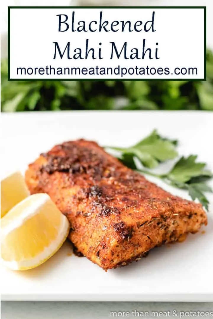 A blackened mahi mahi filet with fresh lemon and parsley.