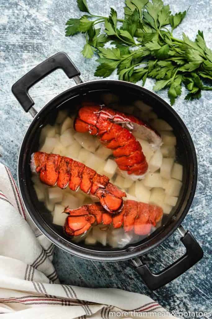 Lobster shells added to salted water and diced potatoes.