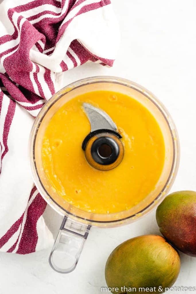 The pureed mango in a food processor.