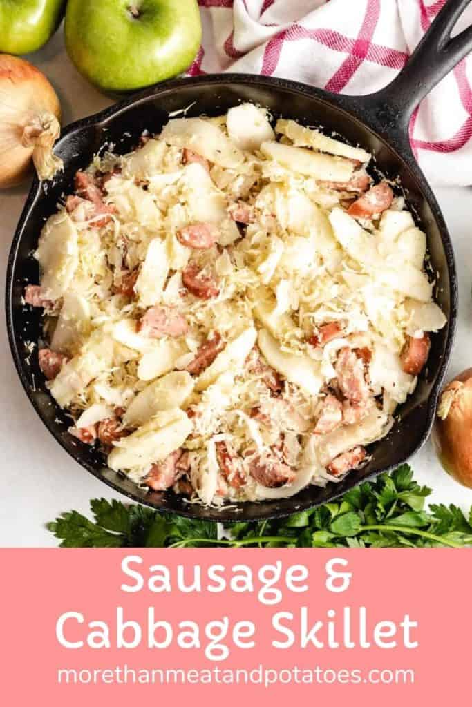 A cast iron skillet filled with cooked sausage and cabbage.