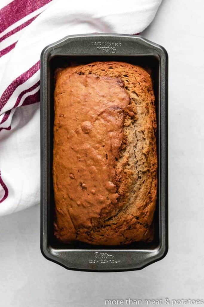 The freshly baked banana bread in a loaf pan.