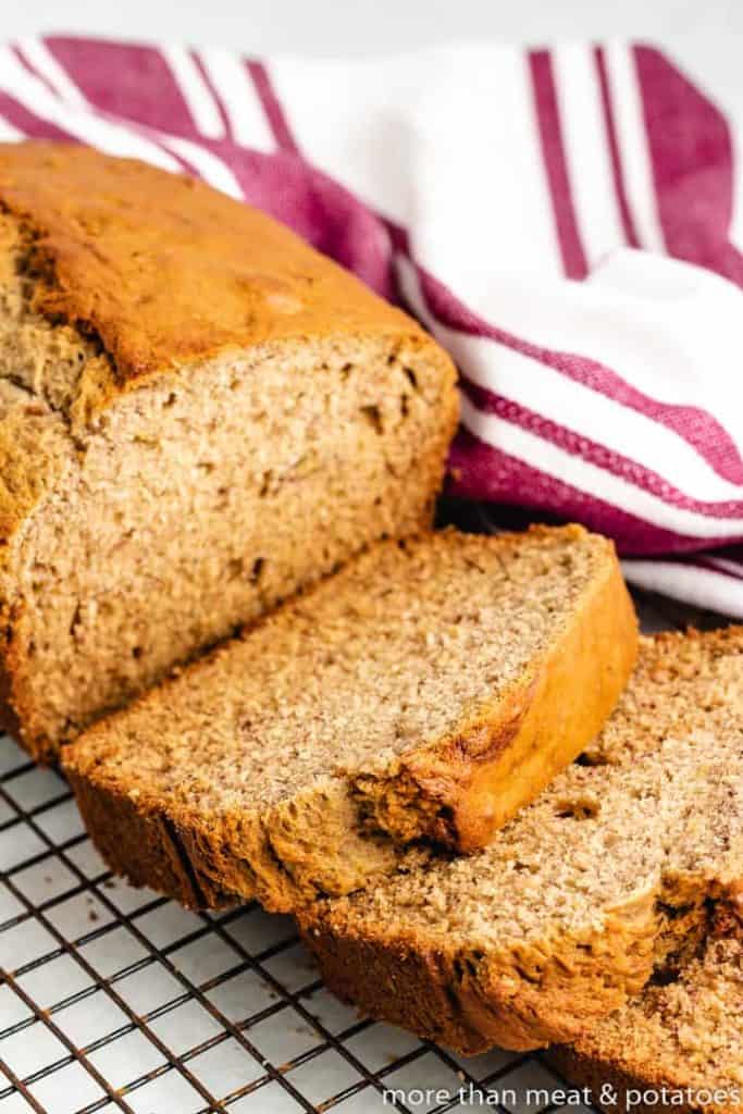 The sliced loaf on a wire cooling rack.