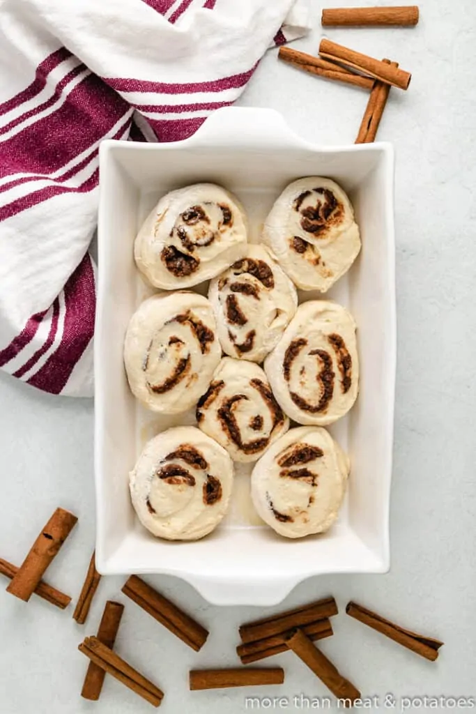 Raw rolls transferred to a baking dish.