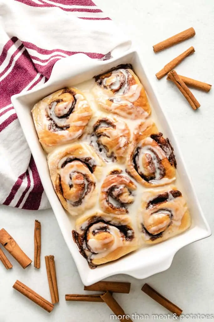 The glaze applied to the fresh baked cinnamon rolls.