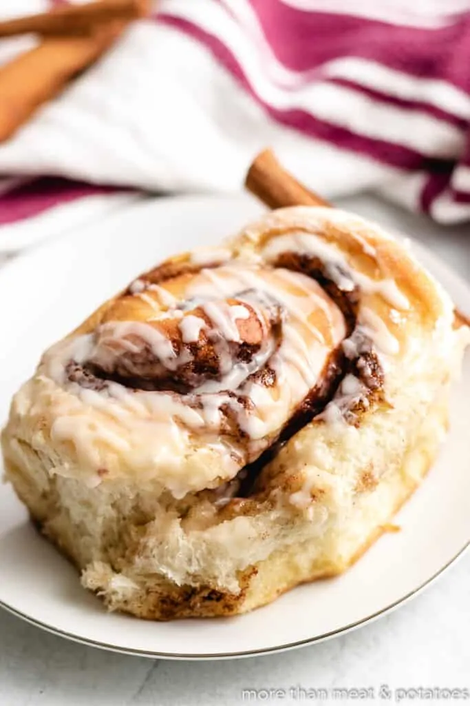 A finished sourdough sweet roll sitting on a plate.