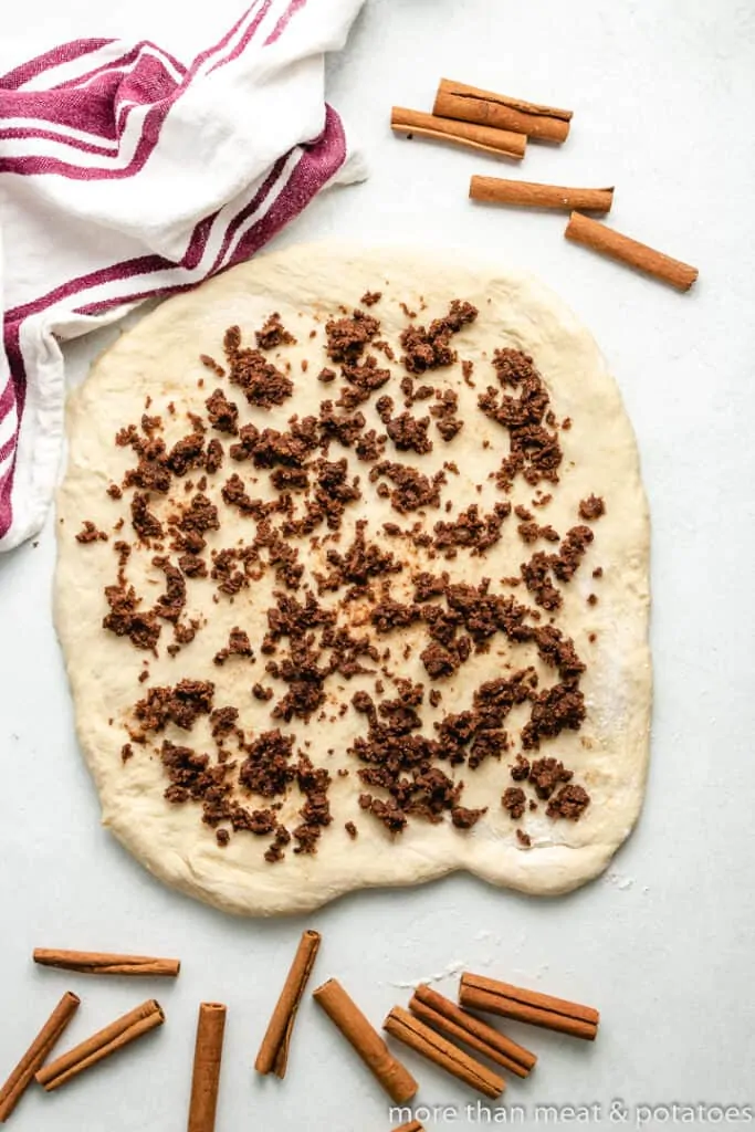 The dough rolled out and sprinkled with filling.