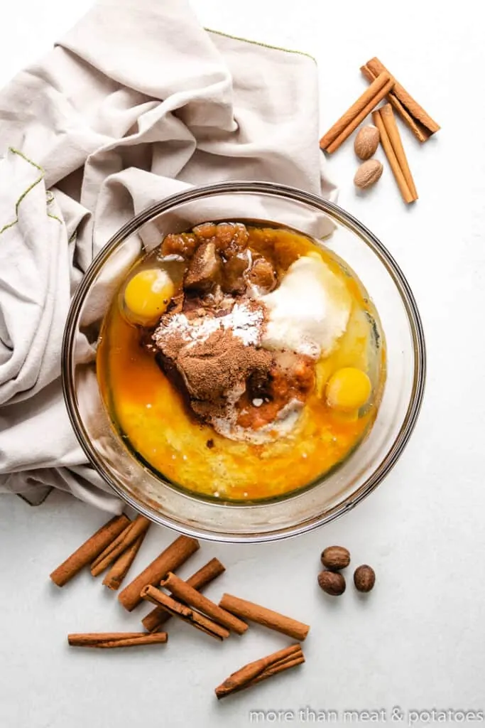 Pumpkin puree and other ingredients in a mixing bowl.