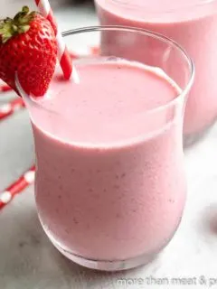 The finished strawberry Greek yogurt smoothie with a straw.