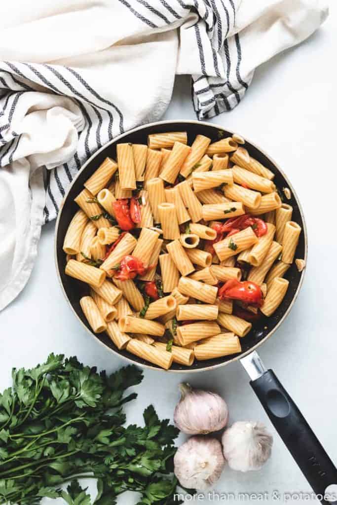 Cooked rigatoni noodles tossed with pasta sauce.