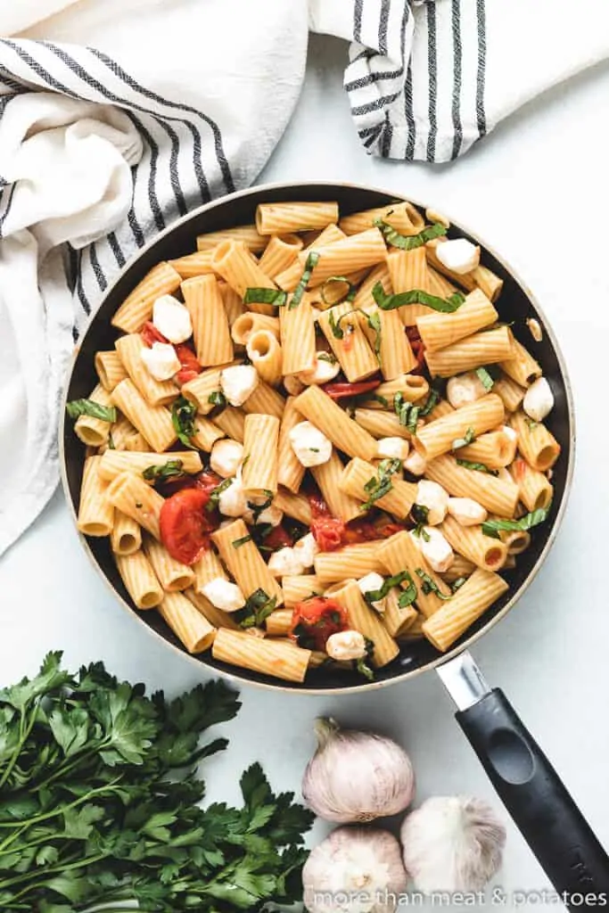 An aerial view of the pasta topped with fresh mozzarella.