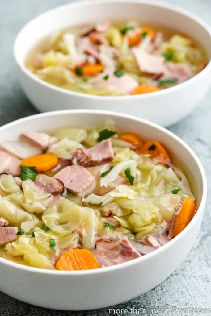 Two bowls of the soup sitting on a table.