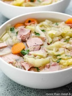 The ham and cabbage soup served in a bowl.