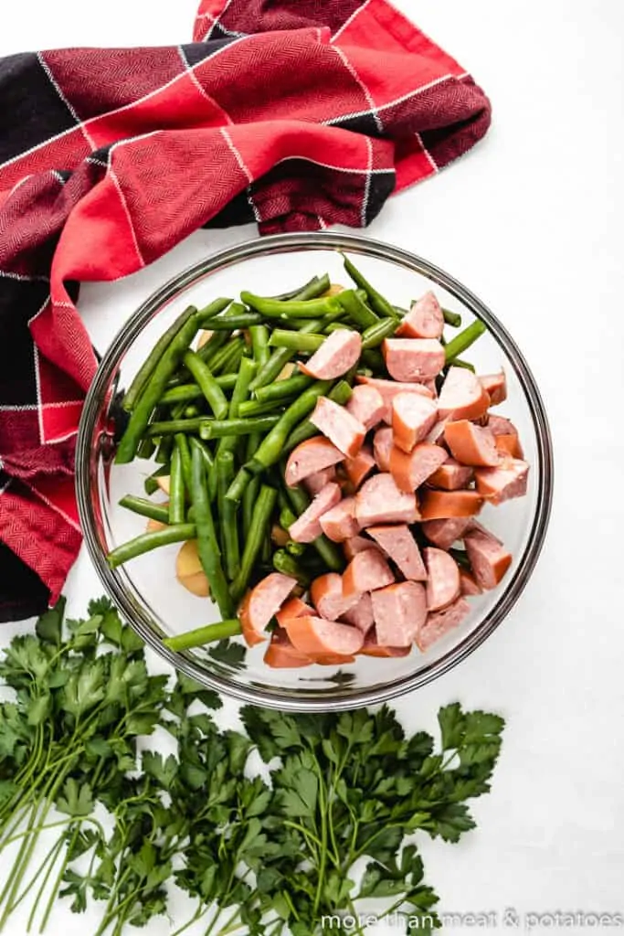 The meat and vegetables in a large mixing bowl.