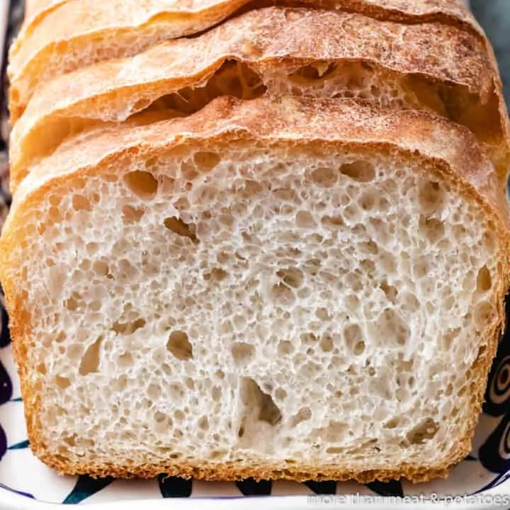 Sliced sourdough sandwich bread on a plate.