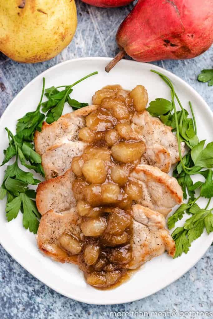 Cast Iron Pork Chops Top-down view of the chops served with a pear topping.