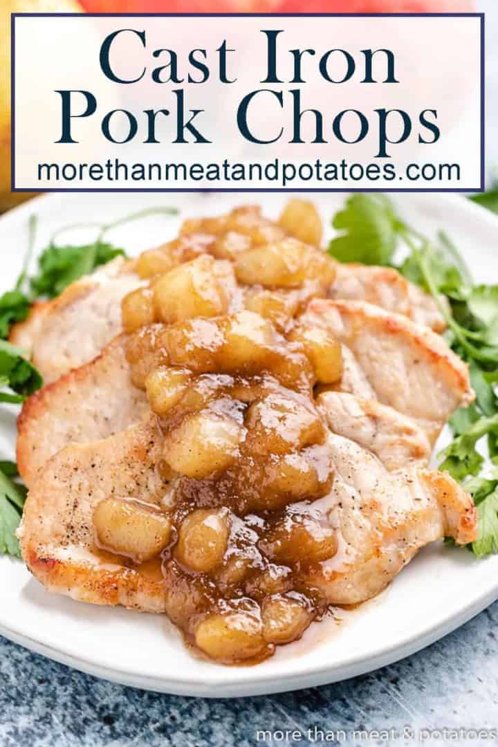 Cast iron pork chops with a pear topping on a plate.